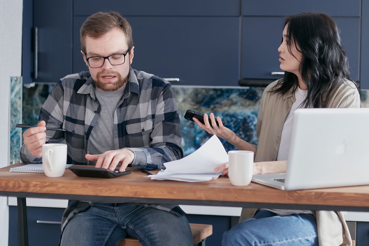 A pair reviewing records on screen