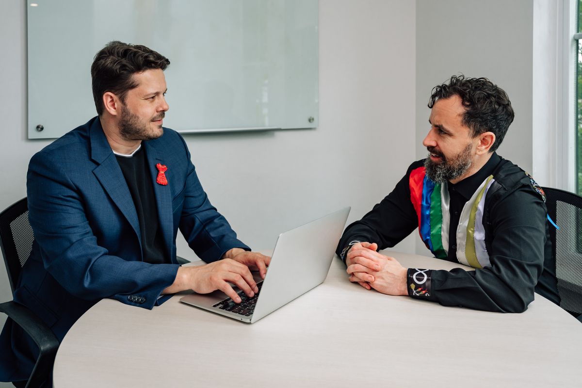 Coworkers comparing notes at a desk